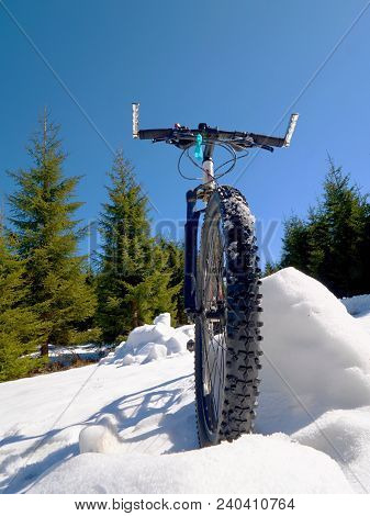 Wide View Photo Of Mountain Bike In Deep Snow. Winter Mountains With Road Lost Under Snow.
