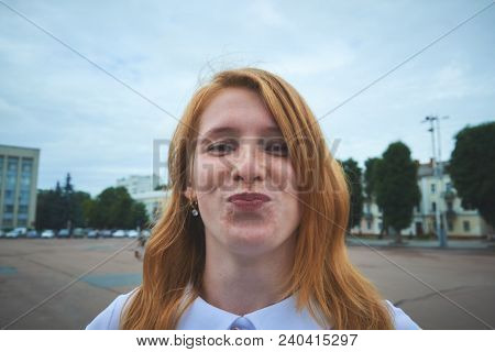Style Portrait Of Pretty Woman On City Background And Look In Kamera. Central Composition
