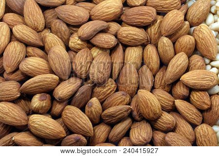 Almond Nuts Background. Close Up Macro Photography Of Expanded Heap Of Brown And Gold Shelled Nuts.