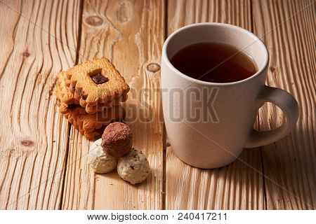 Cup Of Tea With Tasty Cookies On Wooden Background