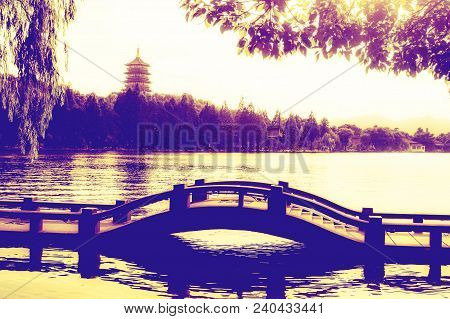Silhouette & Reflection Of Bridge And Leifeng Pagoda At Hangzhou West Lake. Sunset Scene. West Lake 