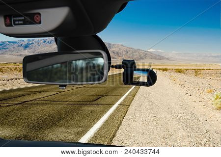 Looking Through A Dashcam Car Camera Installed On A Windshield With View Of A Hot Desert Road In Dea