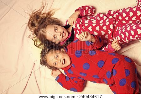 Girl Sisters In Pajamas Happy Smile In Bed, Top View. Children Nightwear Fashion. Bedtime, Slumber, 