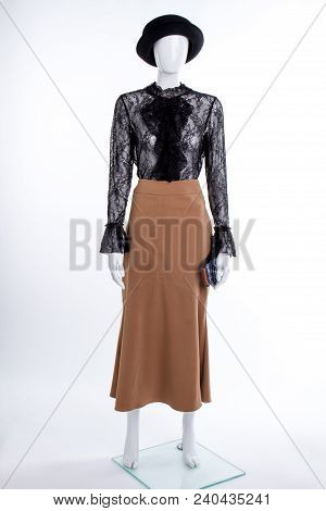 Black Hat And Lace Jabot Blouse. Female Mannequin With Black Hat, Lace Blouse And Brown Skirt. Femin