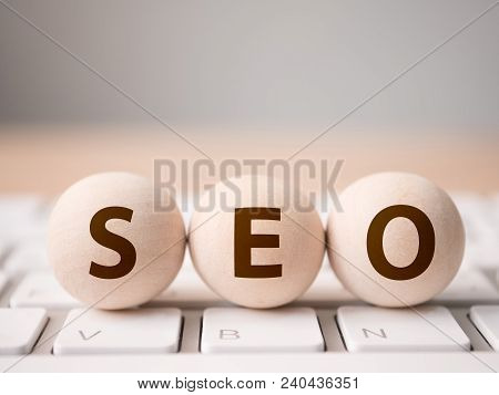 Search Engine Optimization Concept. Wood Block Sphere Shape On Computer Keyboard With Word Seo And E