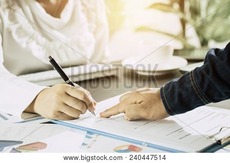 Calculate Budget And Business Planning Concept, Two People Couting Revenue And Expenditure By Using 