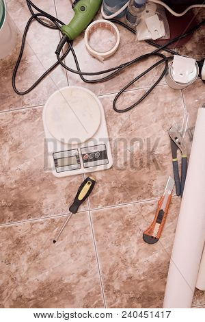 Top View Of Building Equipment With Weigher On Floor In Bathroom