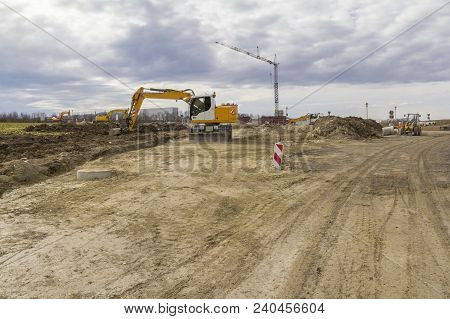 Excavator And Other Construction Machines At A Loamy Construction Site
