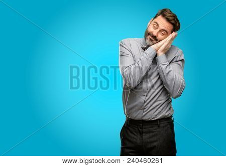 Middle age man, with beard and bow tie tired and bored, tired because of a long day overworking