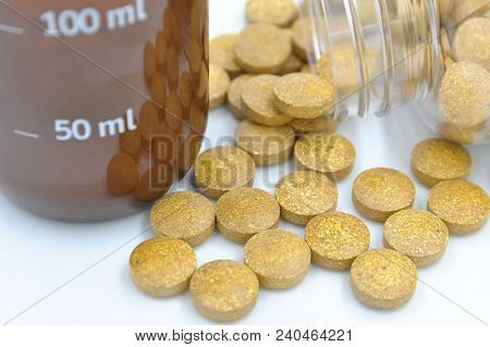 Pills And Cure Flask On White Background