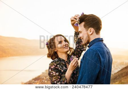 Couple In Love Happily Walks On Bank Of The Riverbackground