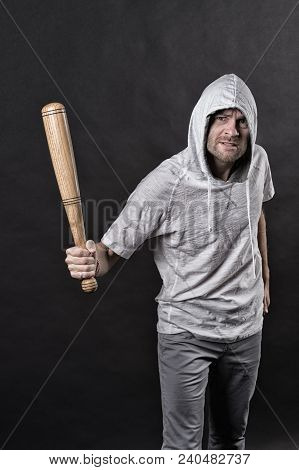 Gangster Guy Threaten With Bat Weapon. Bearded Man Hold Baseball Bat. Hooligan Wear Hood In Hoodie T