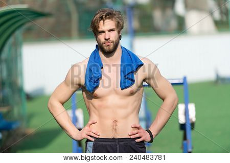 Bearded Man With Fit Torso Muscles At Stadium. Sportsman With Blue Tshirt On Neck. Athlete With Sexy