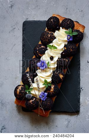 Cake Of Saint-onore From Puff Pastry, Profiteroles, Currant Cream And Whipped Cream. Classic French 