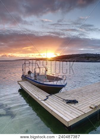 Fishing Boat With Fishing Rods Floating At Shore, Evening Colorful  Sea. Background Beautiful Sky