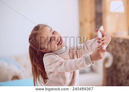 My Photo. Delighted Happy Girl Looking At The Smartphone Camera While Taking Selfie