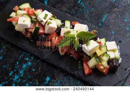 Greek salad with feta cheese cubes and fresk vegetables