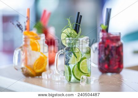 Various Lemonades In Mason Jars With Orange Lime Lemon Otange Strawberries And Fresh Fruit Fruits