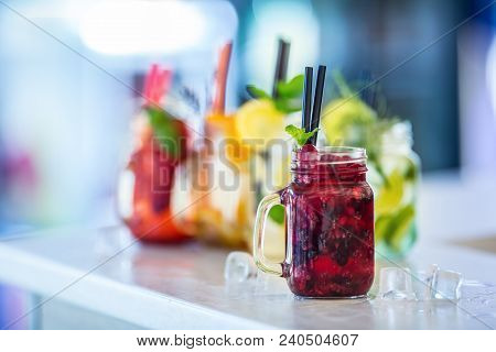 Various Lemonades In Mason Jars With Orange Lime Lemon Otange Strawberries And Fresh Fruit Fruits