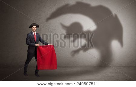 Businessman standing with red cloth in his hand and imp shadow on the background