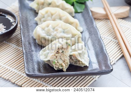 Steamed Korean Dumplings Mandu With Chicken Meat And Vegetables On Black Plate, Horizontal