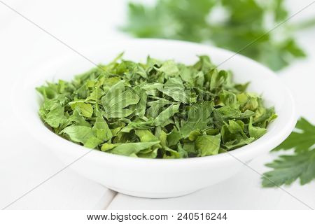 Dried Parsley Leaves In Small Bowl (selective Focus, Focus In The Middle Of The Image)