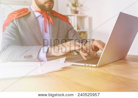 Cropped Image Of Super Businessman In Cape Working With Laptop In Office