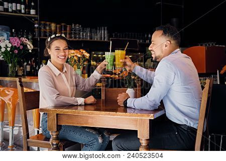 Black American Couple Talks And Drinks, Fresh Juice At A Cafe