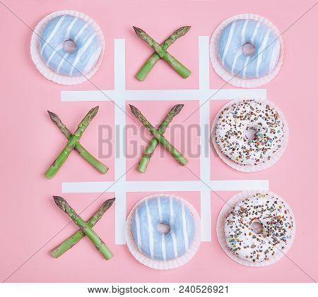 Tik Tak Toe Game With Donuts And Asparagus. Health Nutrition Concept Image