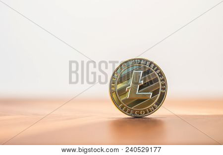 Cryptocurrency Electronic Money Sign, Focus On Metal Litecoins Stack On Wooden Table, Blur White Bac