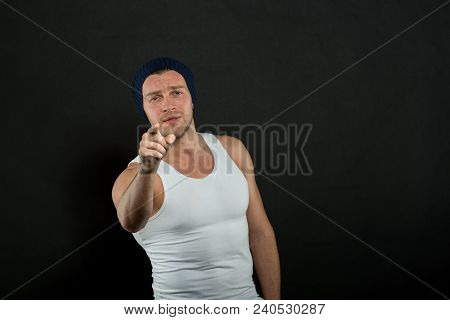 Man With Muscular Arms And Tight T Shirt Pointing Forward. Macho On Confident Face Looks Brutal, Bla