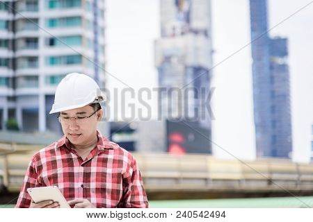 Asian Business And Engineer Man With Red Scott Shirt Has Planning And Working For Design Buiding And