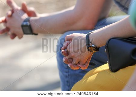 Hands Of A Girl And A Guy With A Clock .