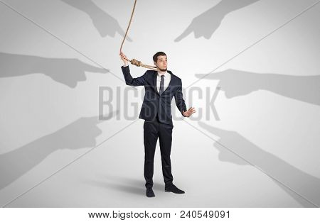 Young businessman trying to suicide with pointing hands concept