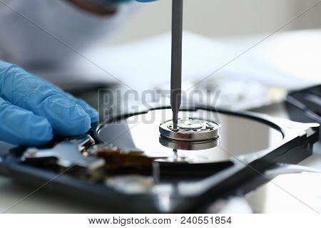 Male Repairman Wearing Blue Gloves Dismantles Specialized Professional Screwdriver Hard Drive. Perfo