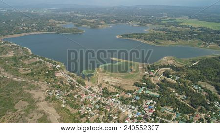 Aerial View Of Paoay Lake Against Background Of Mountains And Sky With Clouds. Paoay Lake National P