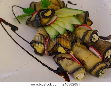 Slices Of Fried Eggplant Stuffed With Philadelphia Cheese With Garlic And Herbs On A Plate