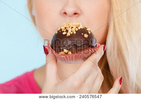 Diet, Sweets, Food Concept. Woman Holding Delicious Chocolate Cupcake With Peanut Frosting About To 