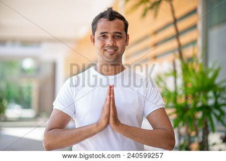 Portrait Of Happy Yoga Practitioner Near Apartment House In Blurred Background. Young Indian Yogi St