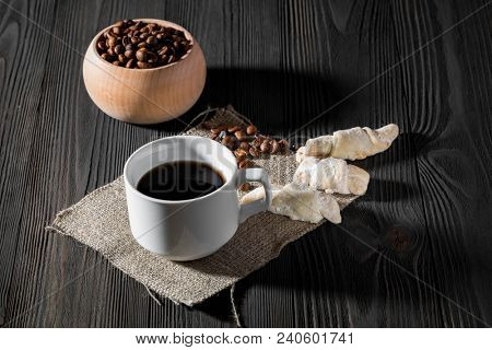 a cup of americano coffee on wood texture, still llife photography