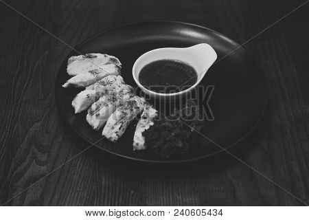 Dish Of Grilled Cheese Served With Raspberry Sauce On Black Plate, Wooden Background. Delicious Chee