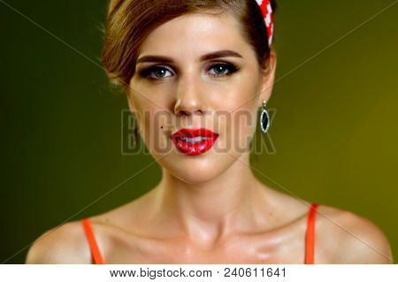 Pin up girl happy and smiling at party. Pin-up retro female style. Girl pin-up style wearing red dress. Portrait of beautiful girl with evening make-up.