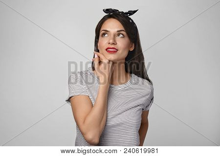 Horizontal Shot Of Attractive Gorgeous Young Brunette Woman Daydreaming, Looking Up With Thoughtful 