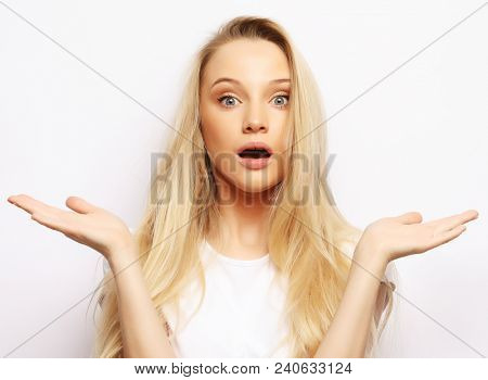 People, body language, emotions concept: Surprised terrified female gestures with uncertainty, stares at camera, puzzled as doesn`t know anwser on tricky question