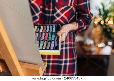 Female Artist Drawing With Pastel Chalk On Eagel Canvas