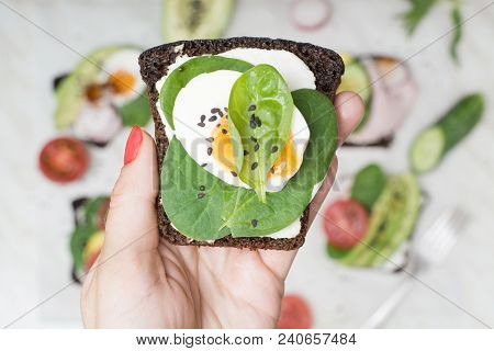 One Sandwich With Fresh Summer Vegetables And Egg In Female Hand. Close Up.