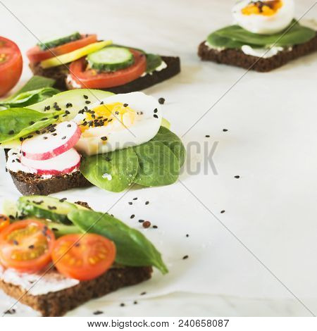 Summer Sandwiches With Vegetables, Eggs, Avocado, Tomato, Rye Bread On Light Marble Table. Appetizer