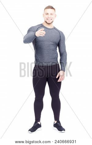 Portrait Of Handsome Well-muscled Gym Instructor In Sports Tights And Rashguard Posing On White Back