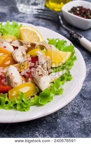 Fish Fillet With Raw Vegetables And Lemon In A Dish On The Table. Selective Focus.