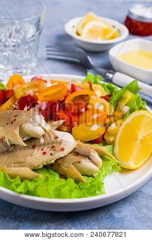 Fish Fillet With Raw Vegetables And Lemon In A Dish On The Table. Selective Focus.